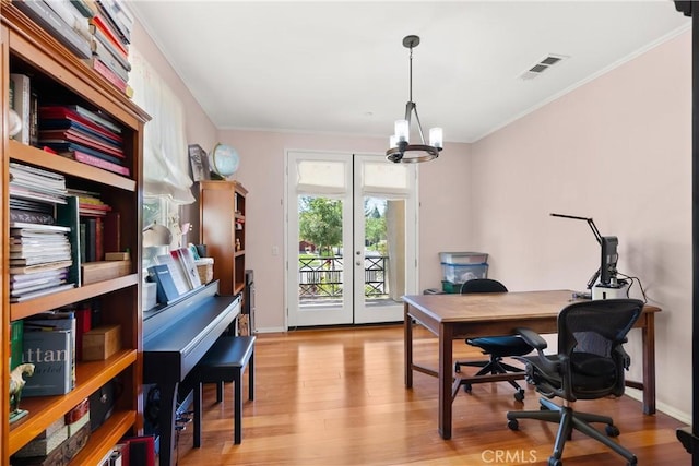 office space with a chandelier, light hardwood / wood-style floors, ornamental molding, and french doors