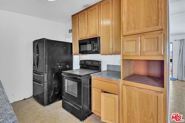 kitchen featuring light tile patterned floors and black appliances