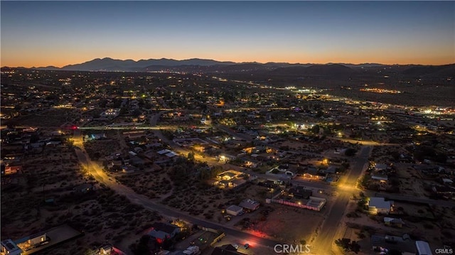 aerial view at dusk featuring a mountain view