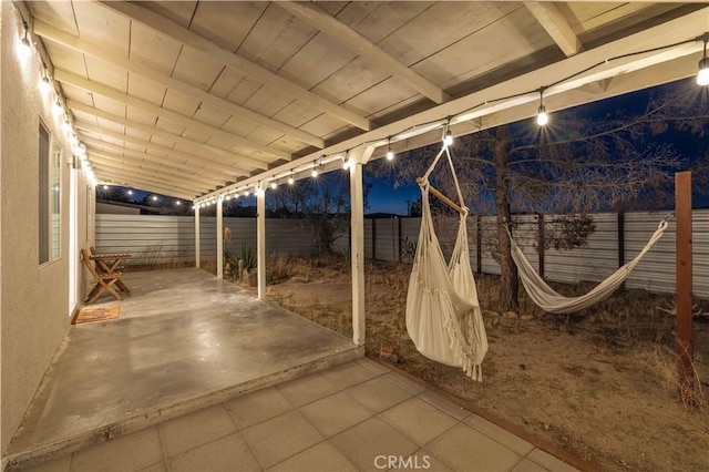 patio at twilight with a fenced backyard