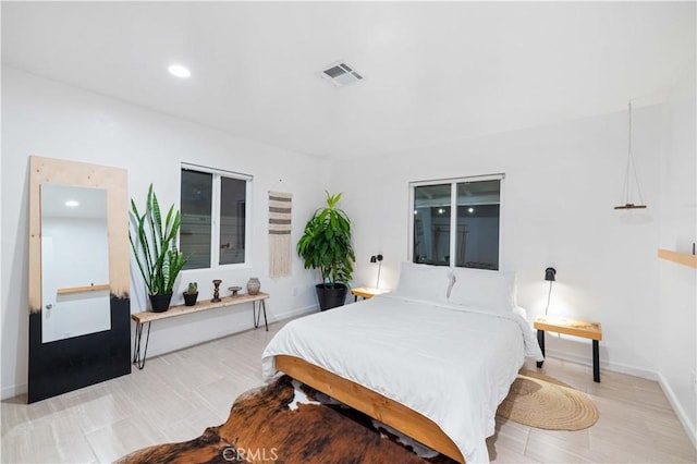 bedroom with baseboards, visible vents, and recessed lighting