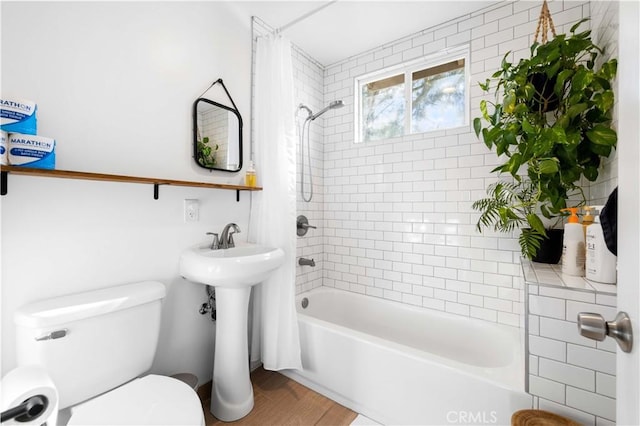 bathroom with shower / bath combination with curtain, toilet, and wood finished floors