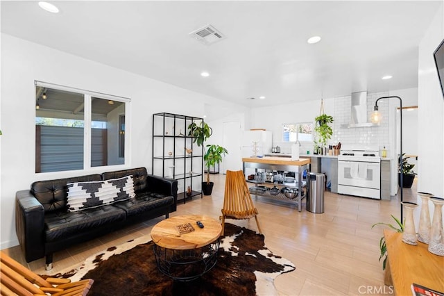 living room featuring visible vents and recessed lighting