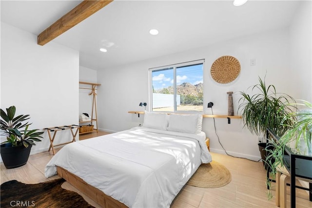 bedroom featuring baseboards, beam ceiling, and recessed lighting