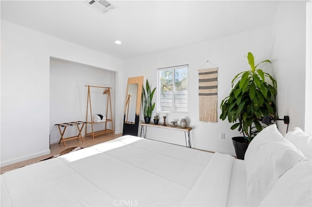 bedroom featuring recessed lighting, visible vents, baseboards, and wood finished floors