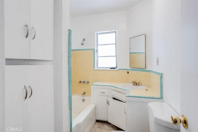 bathroom featuring vanity, a bath, tile walls, and toilet