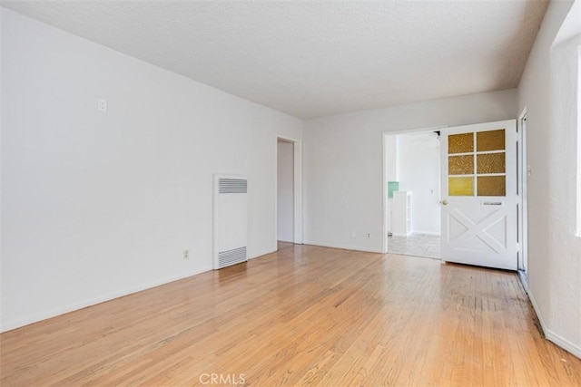 spare room featuring light hardwood / wood-style flooring