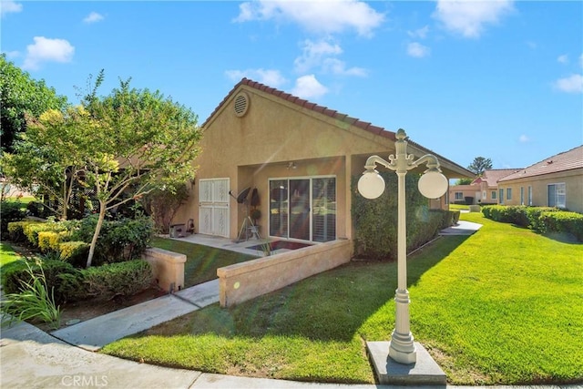 11611 Park Ln, Apple Valley, CA 92308 - view of front of property with a tile roof, a front lawn, and stucco siding