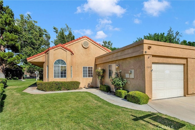 11611 Park Ln, Apple Valley, CA 92308 - mediterranean / spanish-style home with a front yard, stucco siding, driveway, a tiled roof, and an attached garage