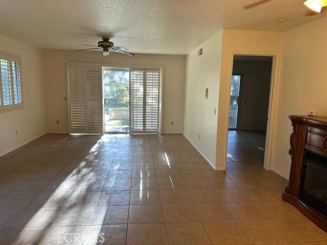 11611 Park Ln, Apple Valley, CA 92308 - empty room featuring tile patterned flooring, ceiling fan, baseboards, visible vents, and a textured ceiling