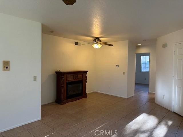 11611 Park Ln, Apple Valley, CA 92308 - unfurnished living room featuring tile patterned floors, a ceiling fan, and a glass covered fireplace