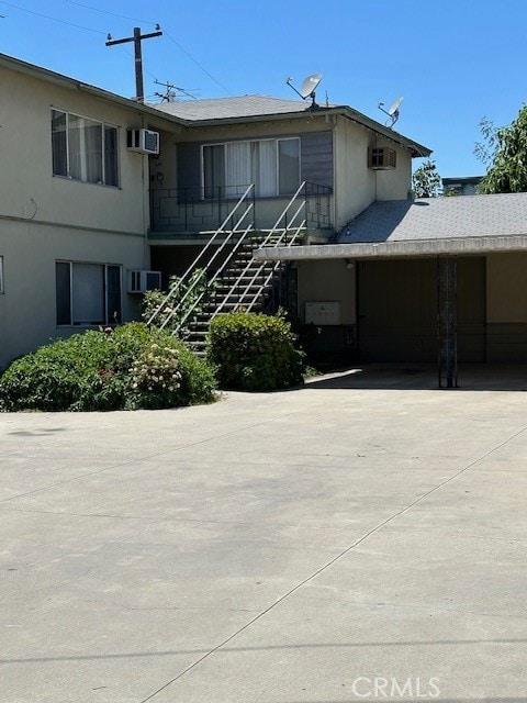 view of building exterior with a wall unit AC