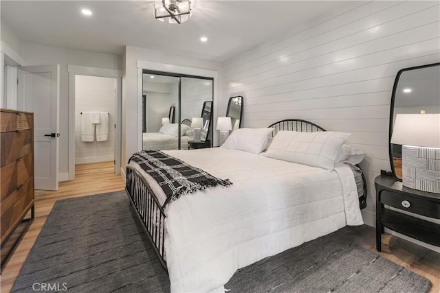 bedroom with a closet and hardwood / wood-style flooring