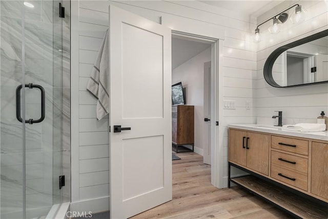 bathroom featuring vanity, hardwood / wood-style flooring, and walk in shower