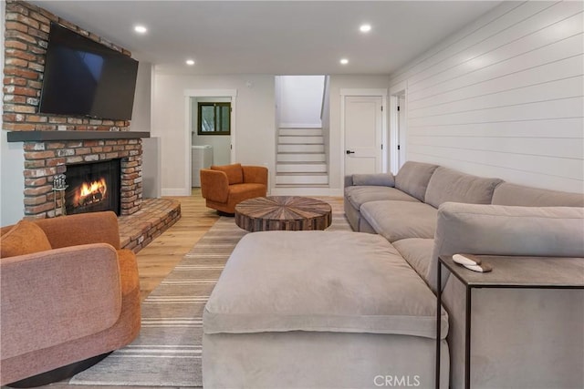 living room with light hardwood / wood-style floors and a fireplace