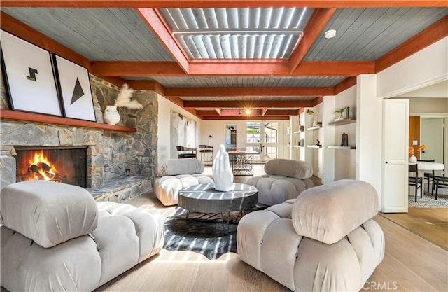 living room with beam ceiling, wood ceiling, and light wood-type flooring