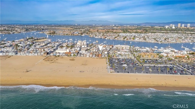 birds eye view of property with a view of the beach and a water and mountain view