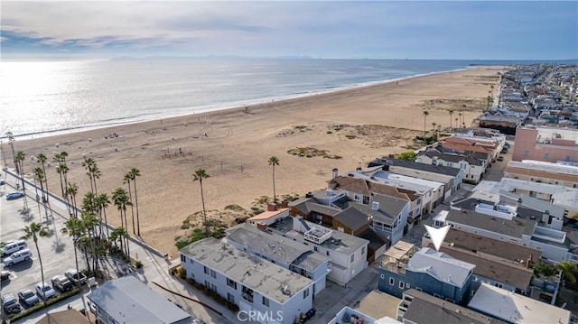 birds eye view of property with a beach view and a water view