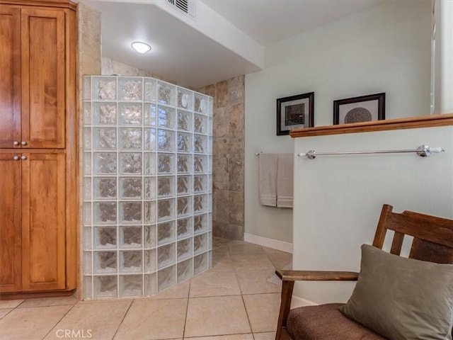 bathroom with tile patterned flooring and walk in shower