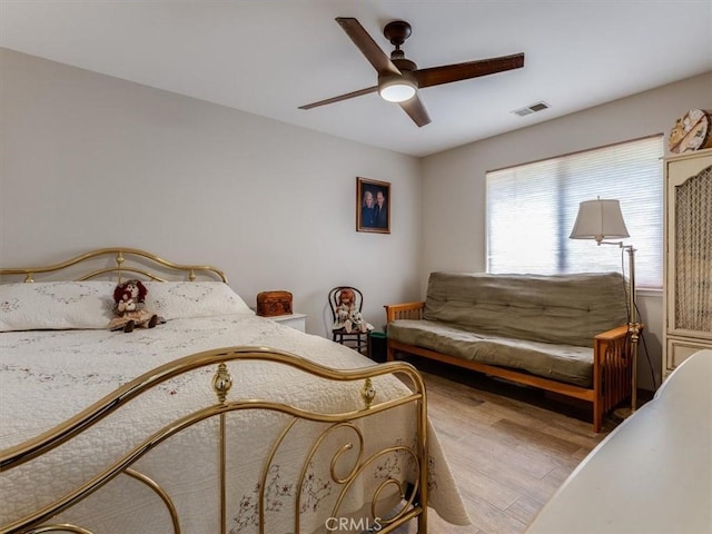 bedroom with ceiling fan and light wood-type flooring