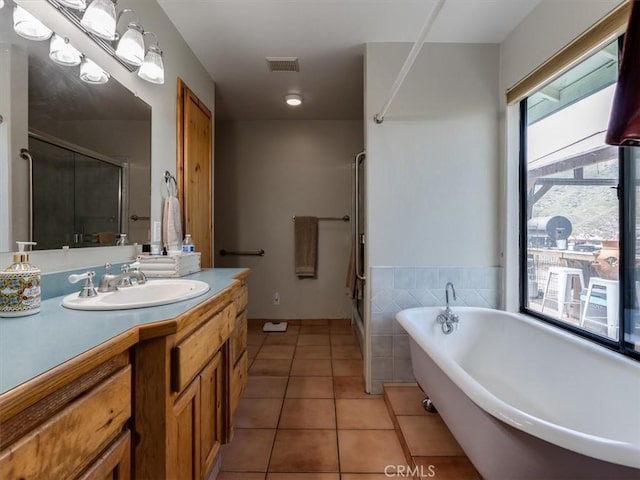 bathroom with tile patterned floors, vanity, and separate shower and tub