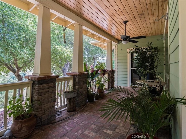 view of patio with ceiling fan and a porch