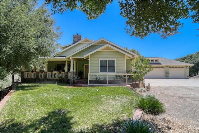 view of front of home featuring a front lawn, a porch, and a garage