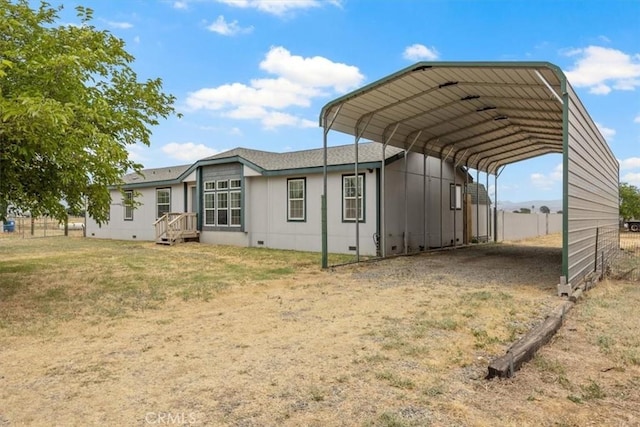 exterior space with a carport and a lawn