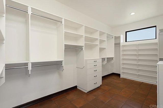 spacious closet featuring dark tile patterned floors