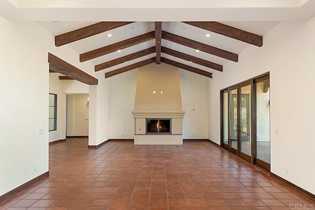 unfurnished living room featuring a fireplace, french doors, tile patterned flooring, and beam ceiling