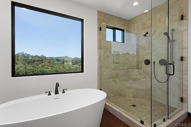 bathroom featuring a stall shower, a soaking tub, tile patterned floors, recessed lighting, and a sink