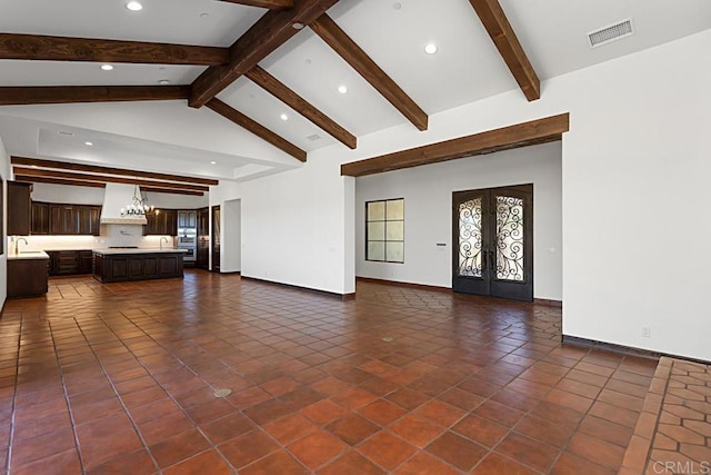 unfurnished living room with visible vents, a wealth of natural light, recessed lighting, and lofted ceiling with beams