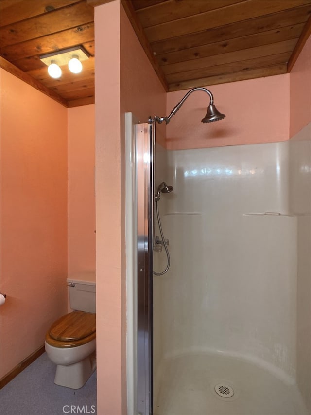 bathroom featuring toilet, a shower, and wood ceiling