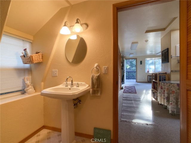 bathroom with tile patterned flooring and lofted ceiling