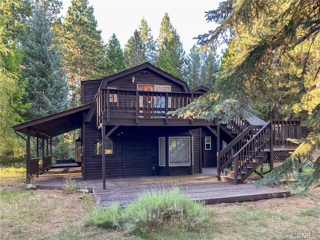 back of house featuring a wooden deck