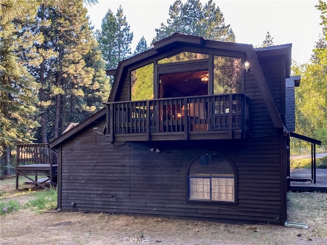 back of house featuring a wooden deck