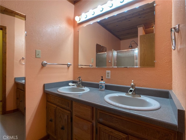 bathroom with dual vanity and wood ceiling