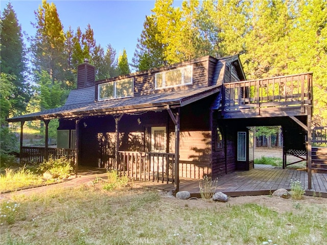 rear view of house with a wooden deck