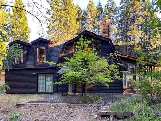 rear view of property featuring a deck