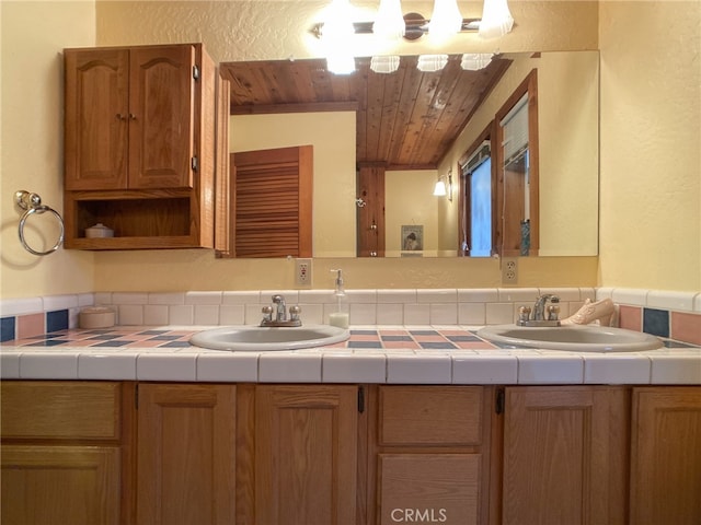 bathroom featuring wooden ceiling and double sink vanity