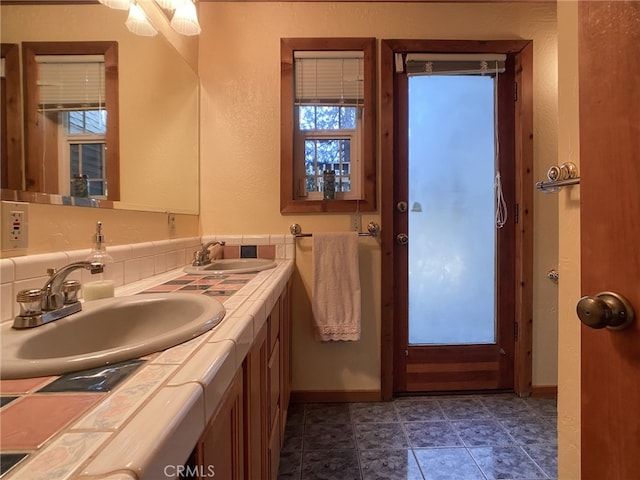 bathroom with tile patterned flooring, dual vanity, and plenty of natural light