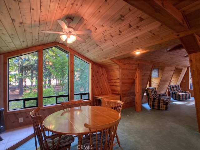 dining room featuring lofted ceiling, carpet flooring, and wood ceiling