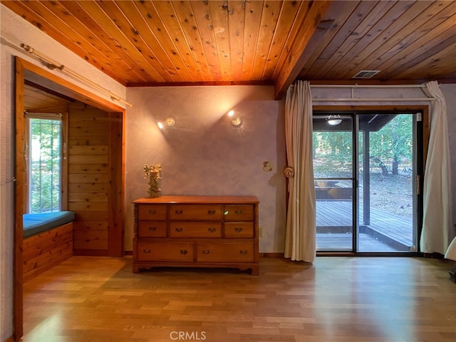 doorway to outside with hardwood / wood-style floors, wood ceiling, and wooden walls