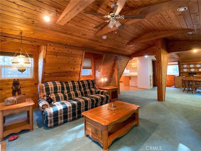 carpeted living room featuring a healthy amount of sunlight, vaulted ceiling with beams, wood ceiling, and rustic walls