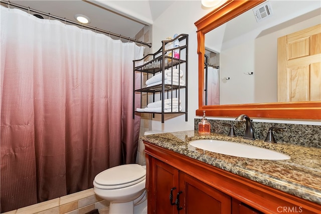 bathroom featuring tile floors, oversized vanity, and toilet