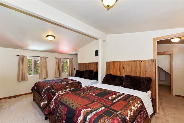 carpeted bedroom featuring lofted ceiling