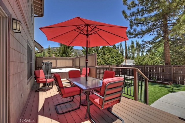 wooden terrace with a lawn