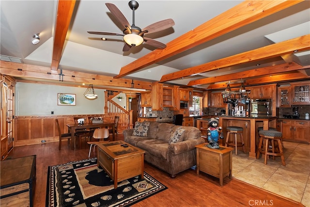 tiled living room featuring beam ceiling and ceiling fan