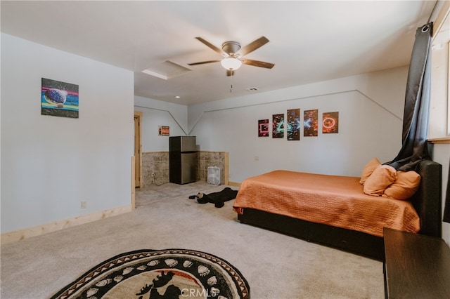 bedroom with carpet, stainless steel fridge, and ceiling fan