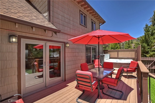 wooden terrace featuring a hot tub and french doors